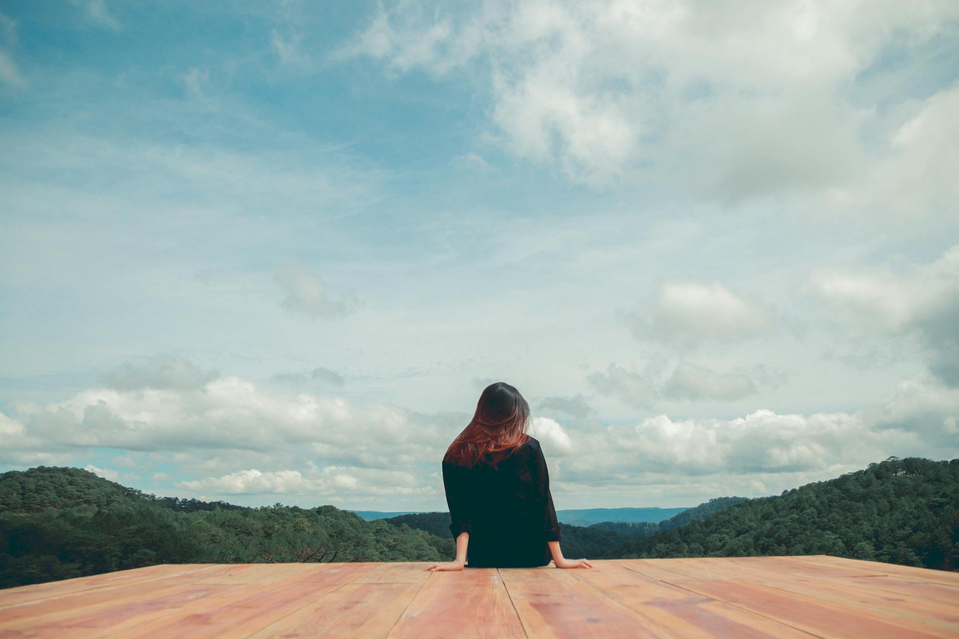 Woman with closed eyes putting hands on her chest